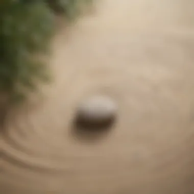 Minimalistic zen garden with ripples in sand and a small stone sculpture