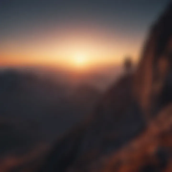 Silhouette of a person climbing a mountain at sunrise